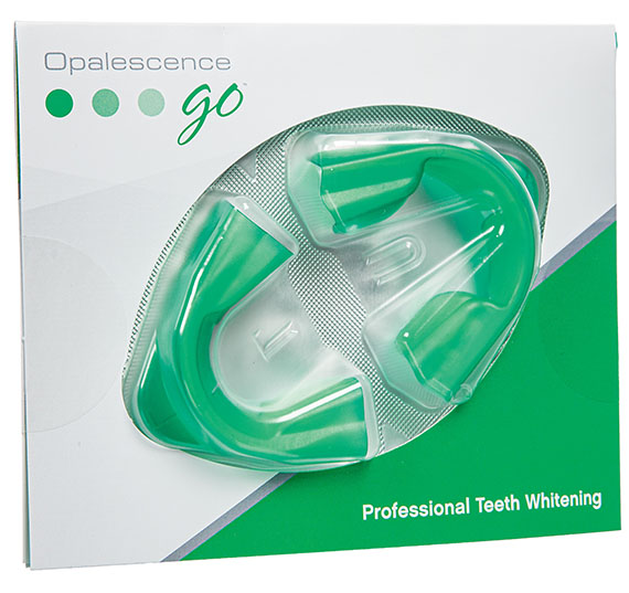 The image shows a package of dental mouthguards with an open plastic container revealing two green toothbrush heads inside, against a white background with some text visible at the bottom.