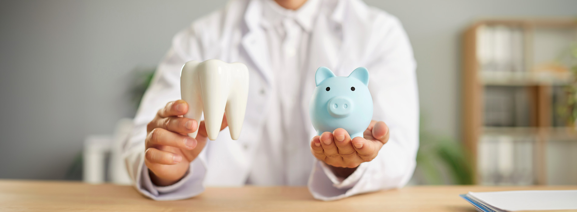 The image shows a person holding two toothbrushes, one blue and one white, with a blurred background depicting an office setting.
